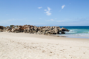 Fototapeta na wymiar Small rocky headland on the beach at Plettenberg Bay South Africa