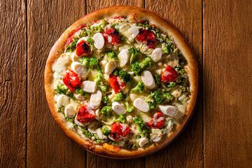 Pizza with broccoli, heart of palm and dried tomato. Top view, close up. Traditional Brazilian Pizza