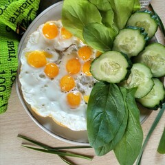 breakfast of fried quail eggs with fresh vegetables