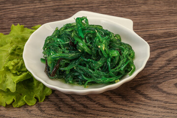 Green Chuka Seaweed Salad Isolated on White Background Top View. Wakame Sea Kelp Salat