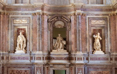 Marble statues decorating niches inside interior wall of italian basilica