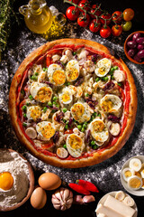 Traditional Portuguese Pizza with egg, olive, palm heart and pea. Top view on black concrete background, close up. Traditional Brazilian Pizza