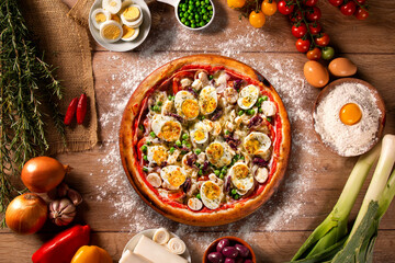 Traditional Portuguese Pizza with egg, olive, palm heart and pea. Top view on wood background, close up. Traditional Brazilian Pizza