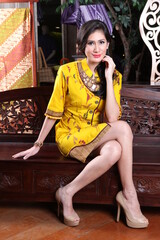 Beautiful woman wearing an elegant batik dress, Batik is a fabric that is painted using canting and liquid wax night so as to form paintings of high artistic value from Indonesia