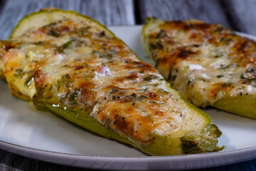 closeup of stuffed zucchini with cheese, bacon and green onion