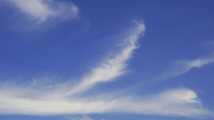 A group of clouds floating in the blue sky was blown to change shape in the summer
