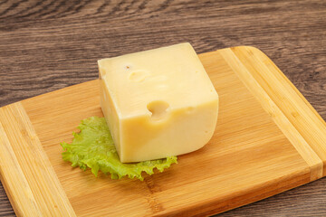 Emmental cheese over wooden board