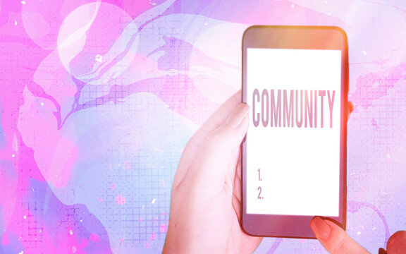 Word writing text Community. Business photo showcasing group of showing with a common characteristics living together Modern gadgets with white display screen under colorful bokeh background