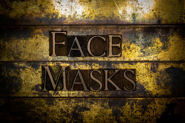 Face Masks text formed with real authentic typeset letters on vintage textured silver grunge copper and gold background