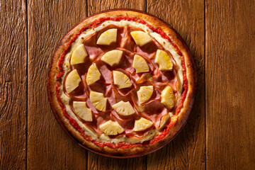 Turkey breast, pineapples and cream cheese Pizza. Top view on wood background, close up. Traditional Brazilian Pizza with smoke.
