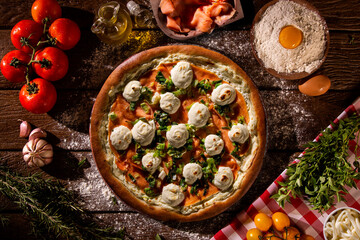 Brazilian pizza with salmon, leek and cream cheese. top view on wood background, close up. Traditional Brazilian Pizza