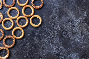 Round pretzels on a dark surface with space for text. Pretzels on the kitchen table with space for text.
