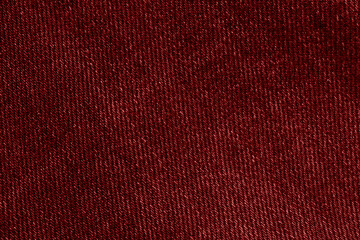 The texture of red jeans. Background of red jeans. Red denim