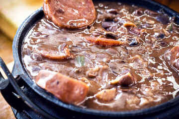 Feijoada mineira, typical food from minas gerais in iron pot.