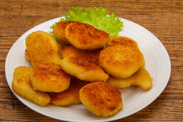 Fried chicken nuggets served salad leaves