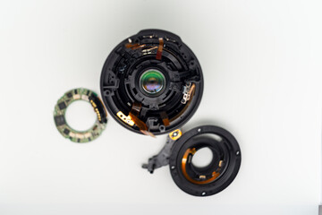 Taken apart camera lens ready for cleaning dust and fixing.