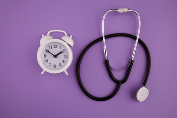 Time is important in life concept. Stethoscope kit and alarm clock.