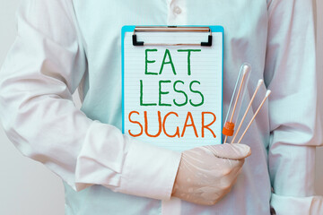 Writing note showing Eat Less Sugar. Business concept for reducing sugar intake and eating a...