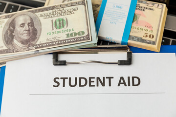 Financial help for student statement. Money on the laptop