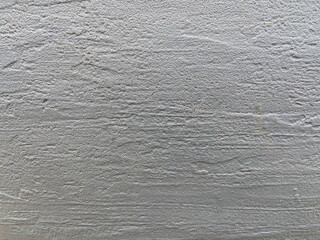 Freshly painted uneven piece of cement wall in gray color
