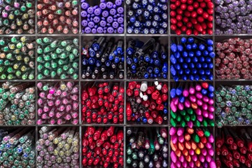 Different color pens in a stationary shop. Office supplies.
