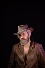 Fototapeta na wymiar Cowboy style. Handsome bearded man in cowboy hat. Sexy western man with hat. Cowboy wearing hat. Western life. Bearded man. Vintage style man.