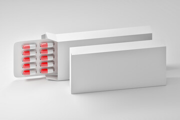 Mockup template with diagonal arrangement of two white medical packaging boxes and red white pills capsules in plastic blister