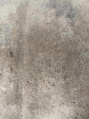 Weather weared piece of cement wall in gray