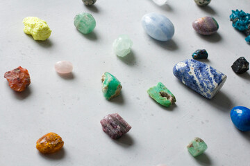 Beautiful bright multi-colored collection of natural stones and minerals from around world lies on...