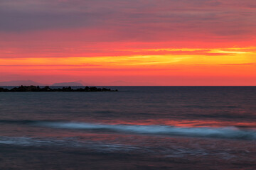 Sunrise at the beach In Monolithos on the island of Santorini in Greece.