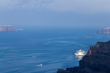 View of the sea and coast on the island of Santorini caldera in Greece. The background is a blue sky.