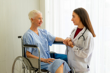 Obraz premium caucasian medical doctor physician diagnosed senior citizen femal patient on wheelchair in the hospital