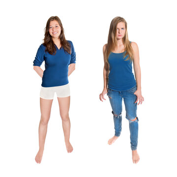 Two barefoot teenage girls wearing casual clothing, full length portraits isolated in front of white studio background