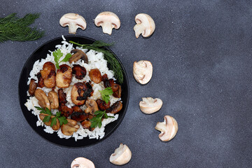 Homemade Italian risotto with mushrooms and ingredients for cooking, champignons, cherry tomatoes and spices on a light table, top view, place for text