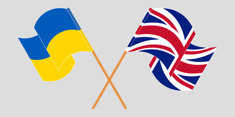 Crossed and waving flags of the Ukraine and the UK