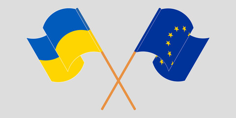 Crossed and waving flags of the Ukraine and the EU