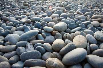 many smooth grey and tan rocks stones pebbles on the shore in lima peru horizontal