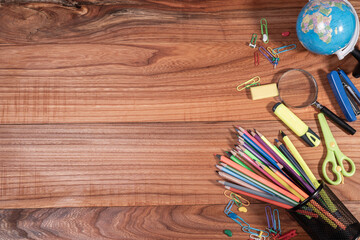 Fototapeta na wymiar back to school concept. stationery items on wooden table, top view