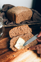 Sliced Homemade wholemeal bread with butter. Easy Cooking of healthy bread from alternative flours