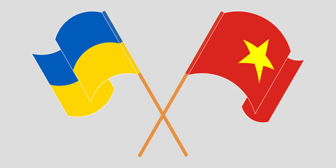 Crossed and waving flags of Ukraine and Vietnam