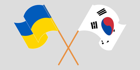 Crossed and waving flags of the Ukraine and South Korea