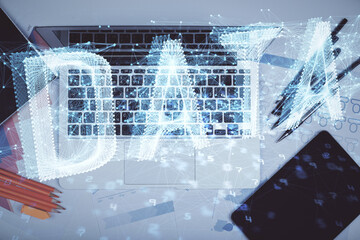 Multi exposure of data drawing hologram over topview of study desk background with computer. Concept of technology.