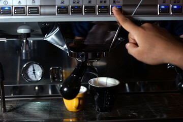 Barista making coffee using a coffee maker