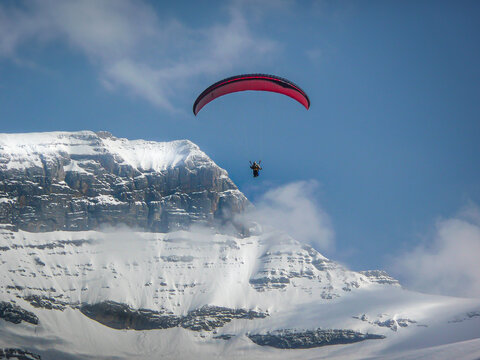 A man paragliding in Swiss Alps
