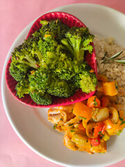 Fish baked with vegetables and brocolli in heart shaped bowl