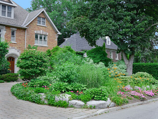 Residential street with large homes and  front gardens
