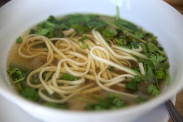 vegan Pho vietnamese soupe with noodles bowl close-up. Healthy and vegetarian food concept