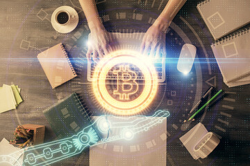 Double exposure of woman hands working on computer and blockchain theme hologram drawing. Top View. bitcoin cryptocurrency concept.