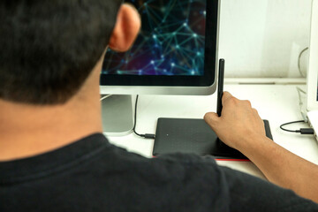 Hands working on computer on his graphics tablet.