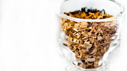 transparent container filled with instant coffee. unusual glass jar filled with coffee on a white background.